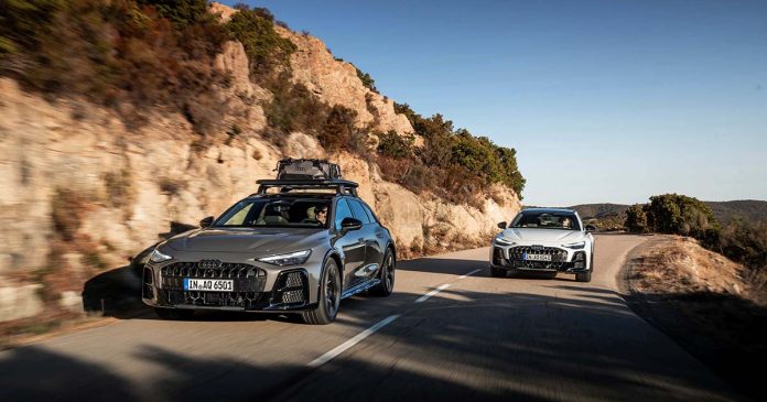 Dois Audi A6 allroad com sistema quattro ultra circulam numa estrada sinuosa, junto a uma encosta rochosa